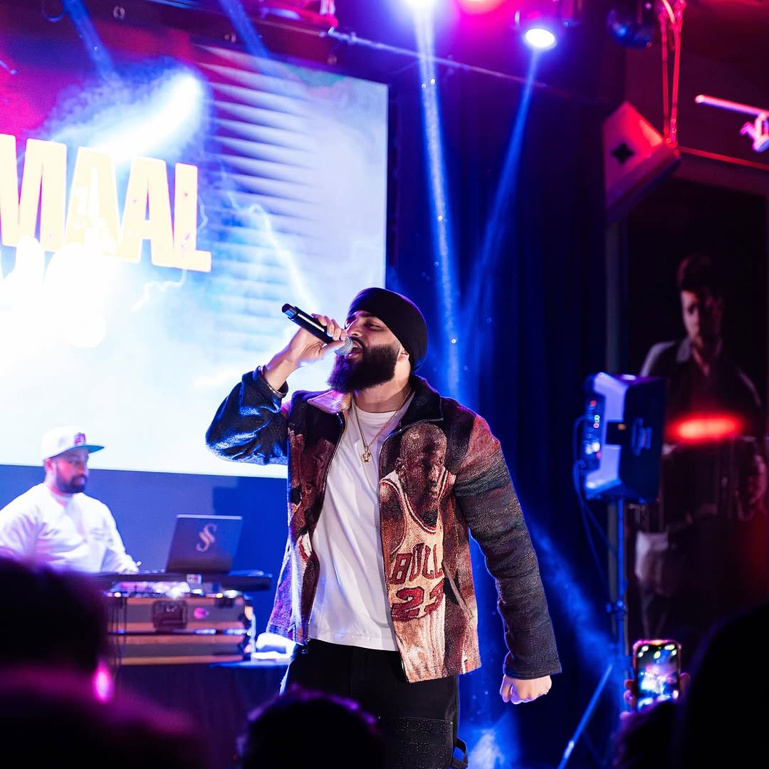 Artist performing in front of the Dhamaal screen in Seattle