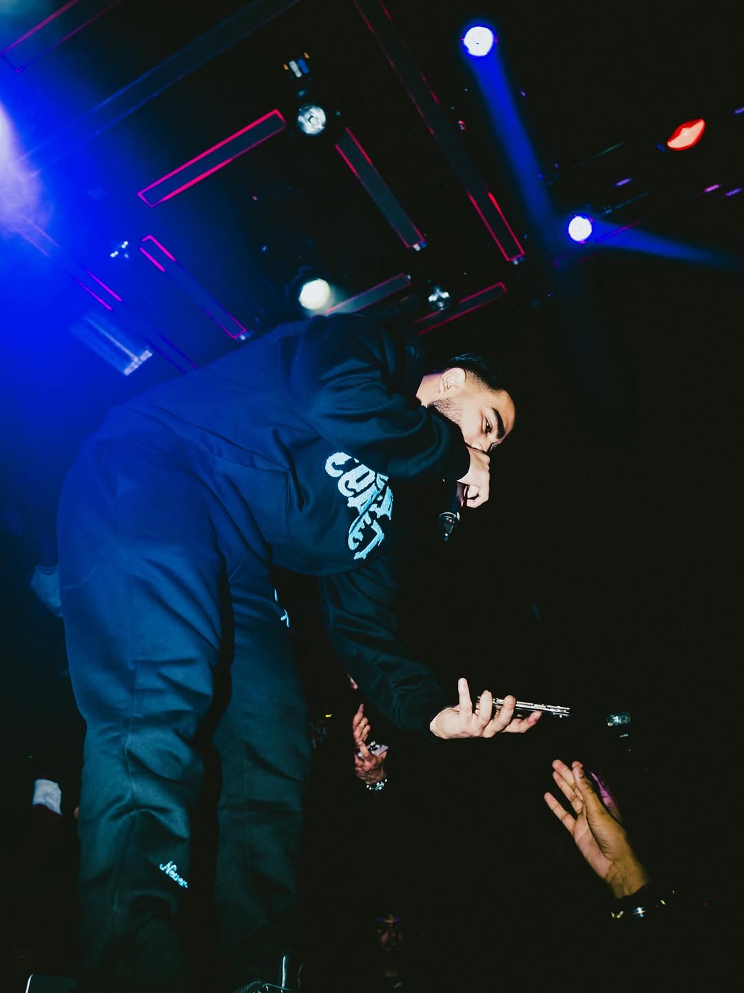 Artist leaning into the Toronto crowd at 44