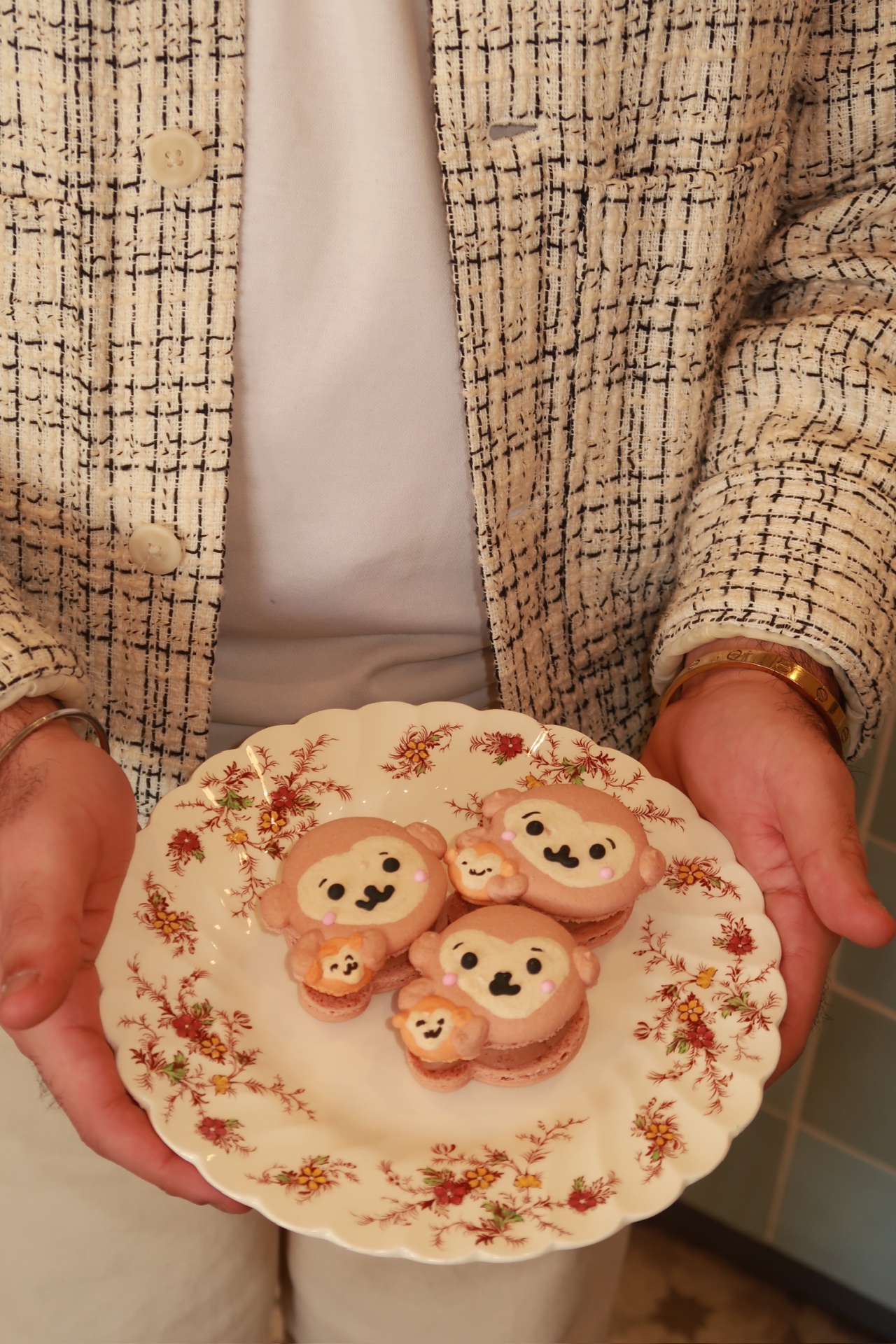 Plate of Punch Monkey character macarons held in hand