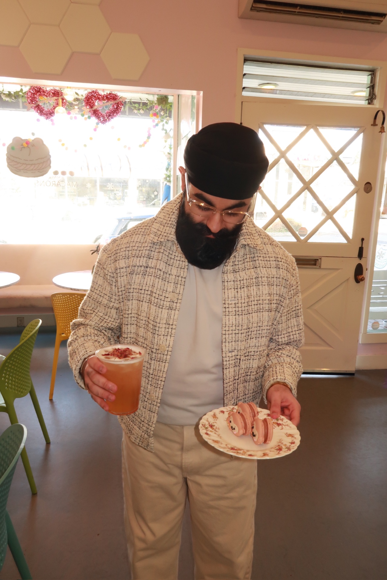 Holding the drink and macaron plate in the OHH! Macarons shop